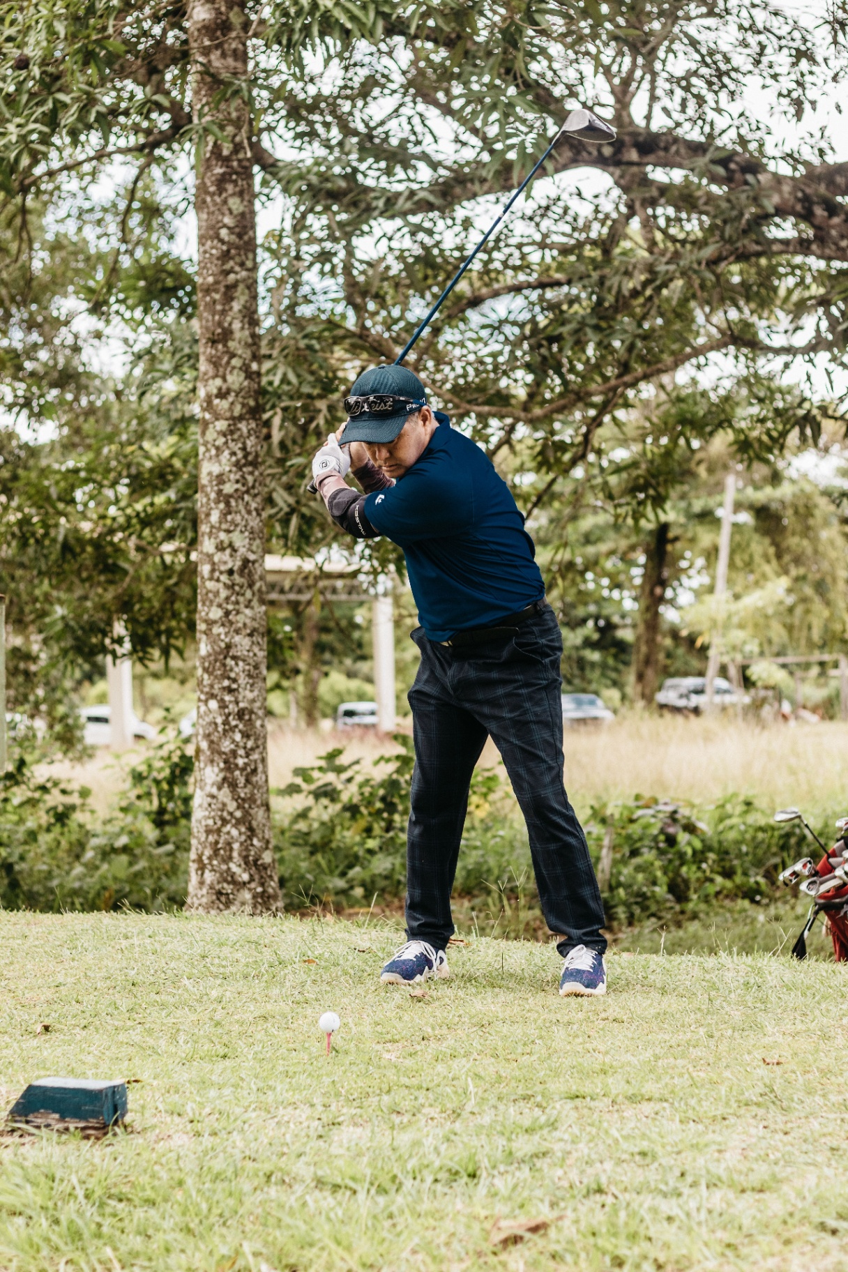 Golfer at the top of the backswing on a fairway